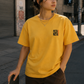 A female skateboarder modeling PIZZANISTA! BASIC BLADE SIGN LOGO TEE in Downtown Los Angeles. 